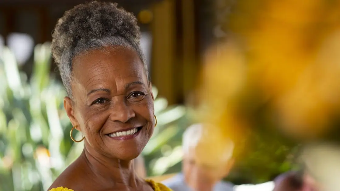 front view of older black woman smilingc elebrating