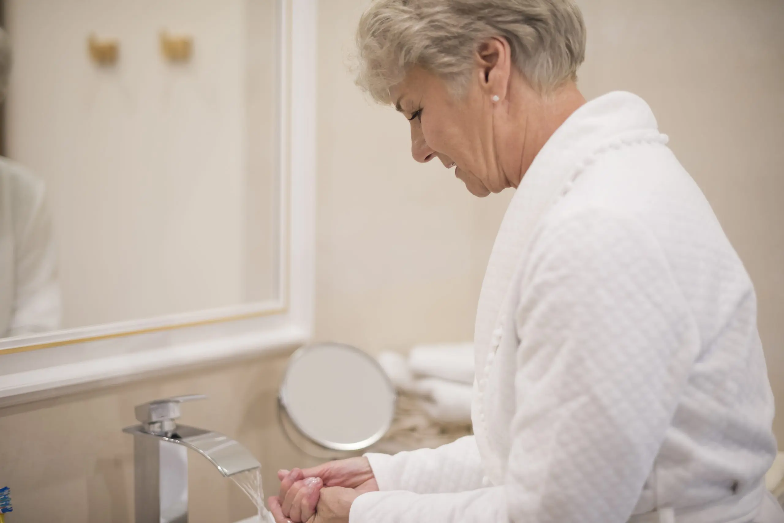 woman washing hands in bathroom