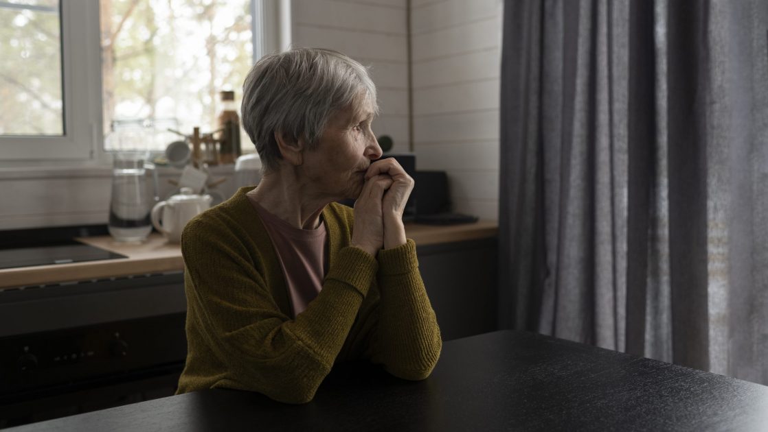 senior woman sitting at table